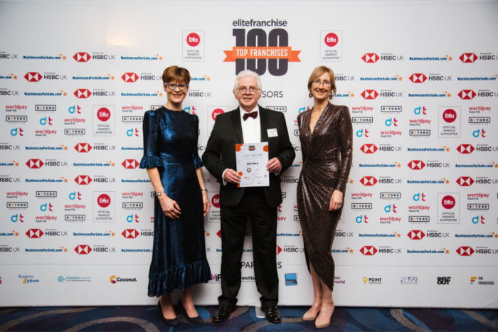 Petpals accepting EF100 award at ceremony.
